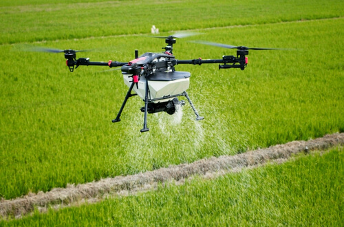 XAG P150 Max agricultural drone spraying crops in a green paddock