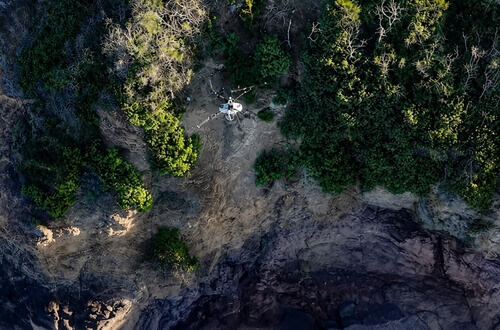 Top-down view of XAG P150 Max drone working along a coastal cliff face